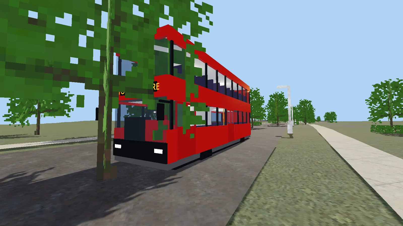 A red double-decker bus pulled in at a stop on a tree-lined road.