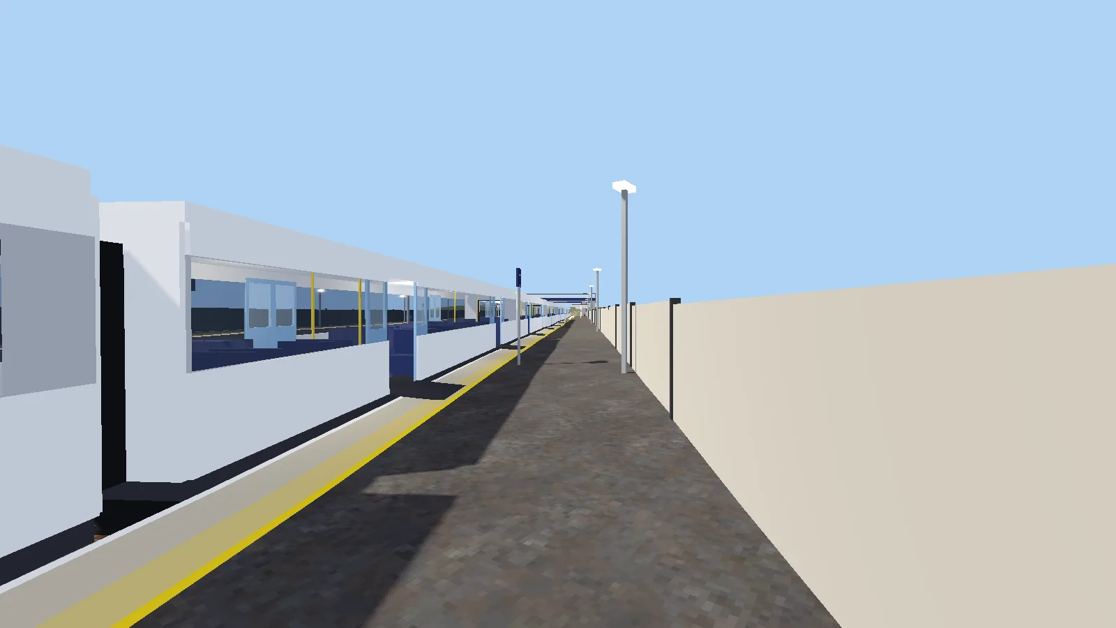 A long white commuter train stopped at a platform with its doors open.