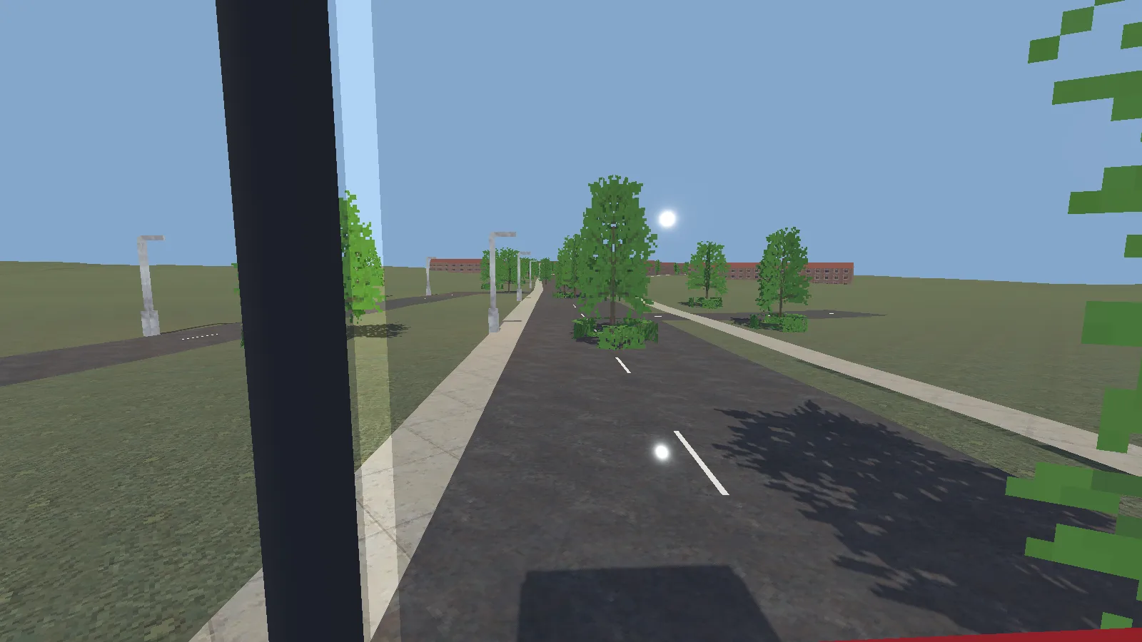 The view from the front seat of a double-decker's top deck, looking down a tree-lined road in the morning.